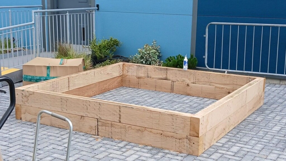 Wooden plant bedding being assembled