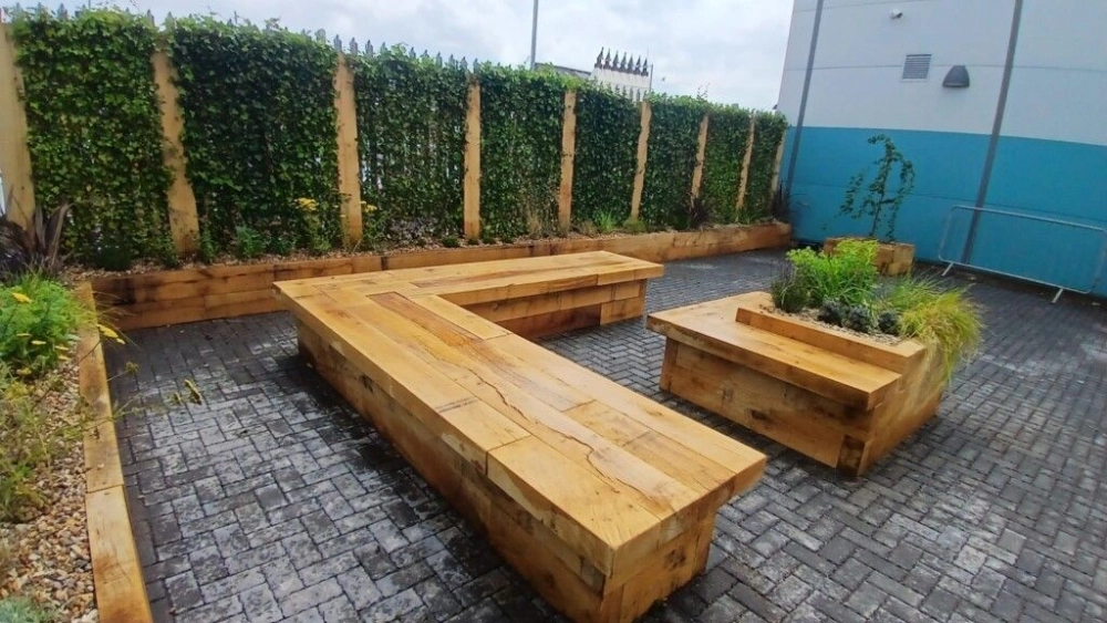 Wood benches next to plants