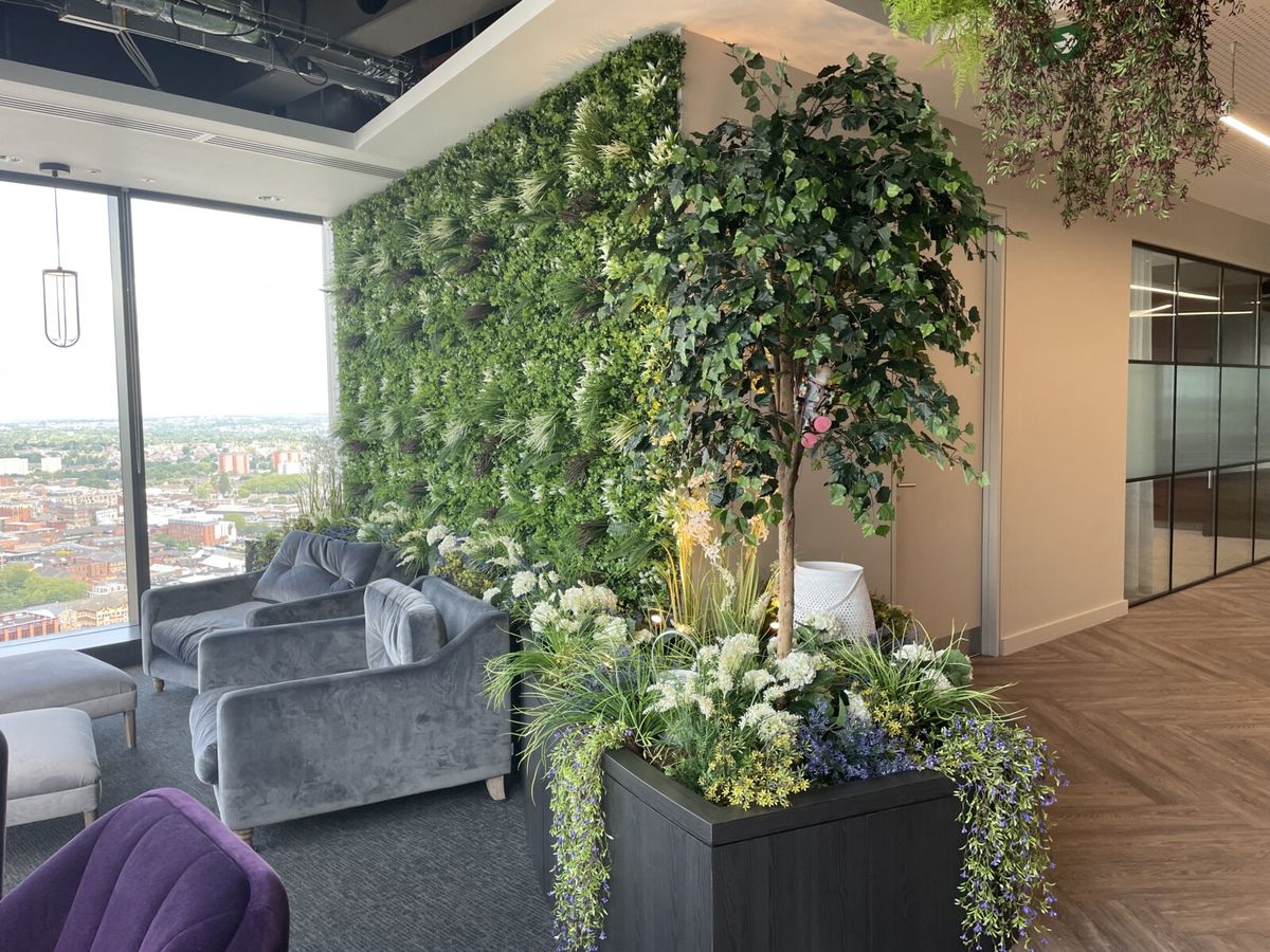 a green wall with plants in a office