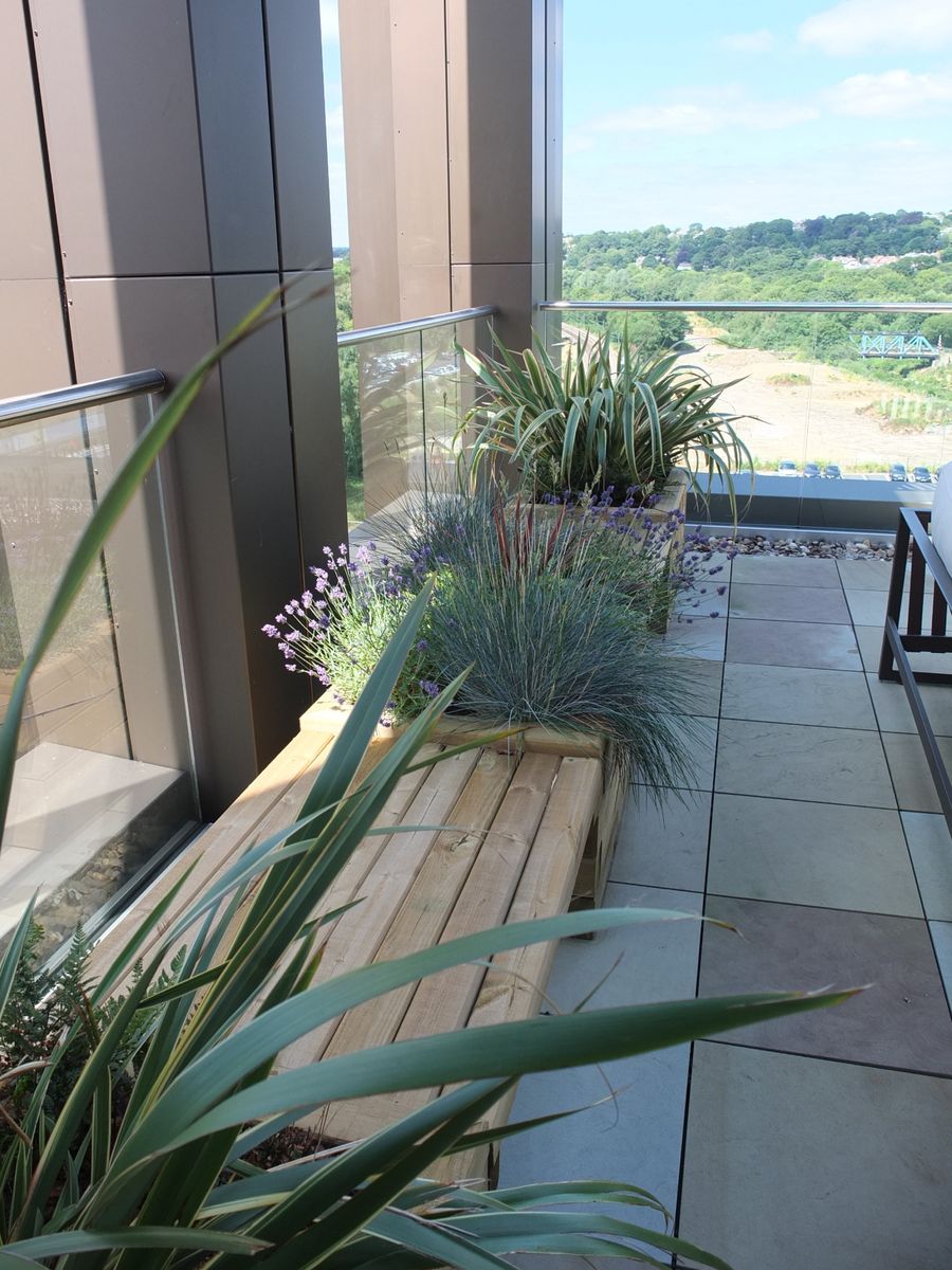 balcony area with plants and benches