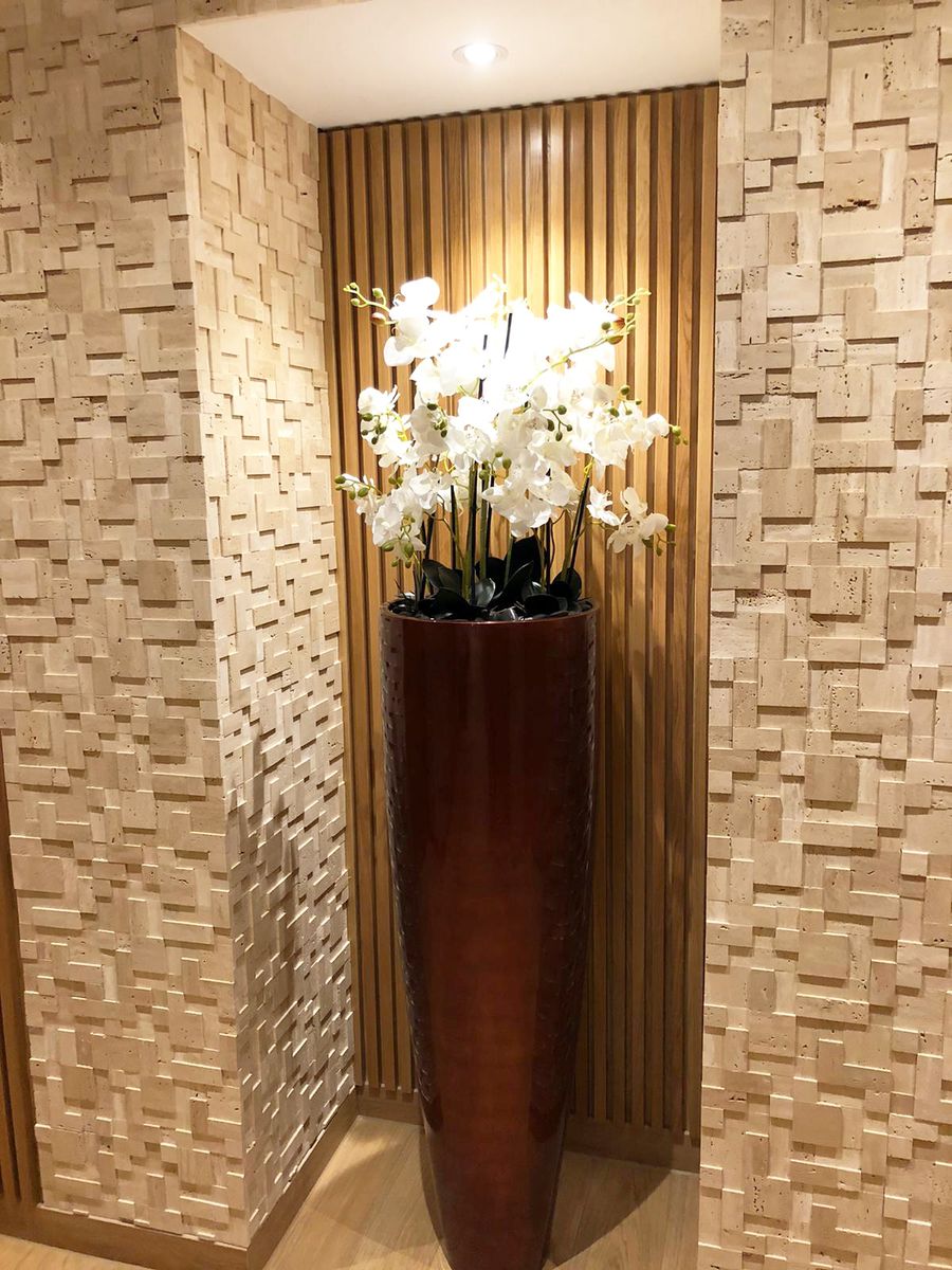flower in a long pot by the wall