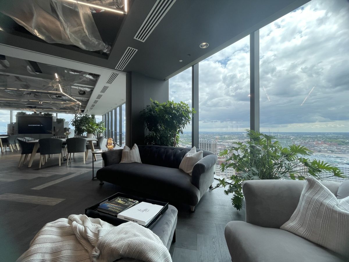office plants next to a seating area overlooking a city