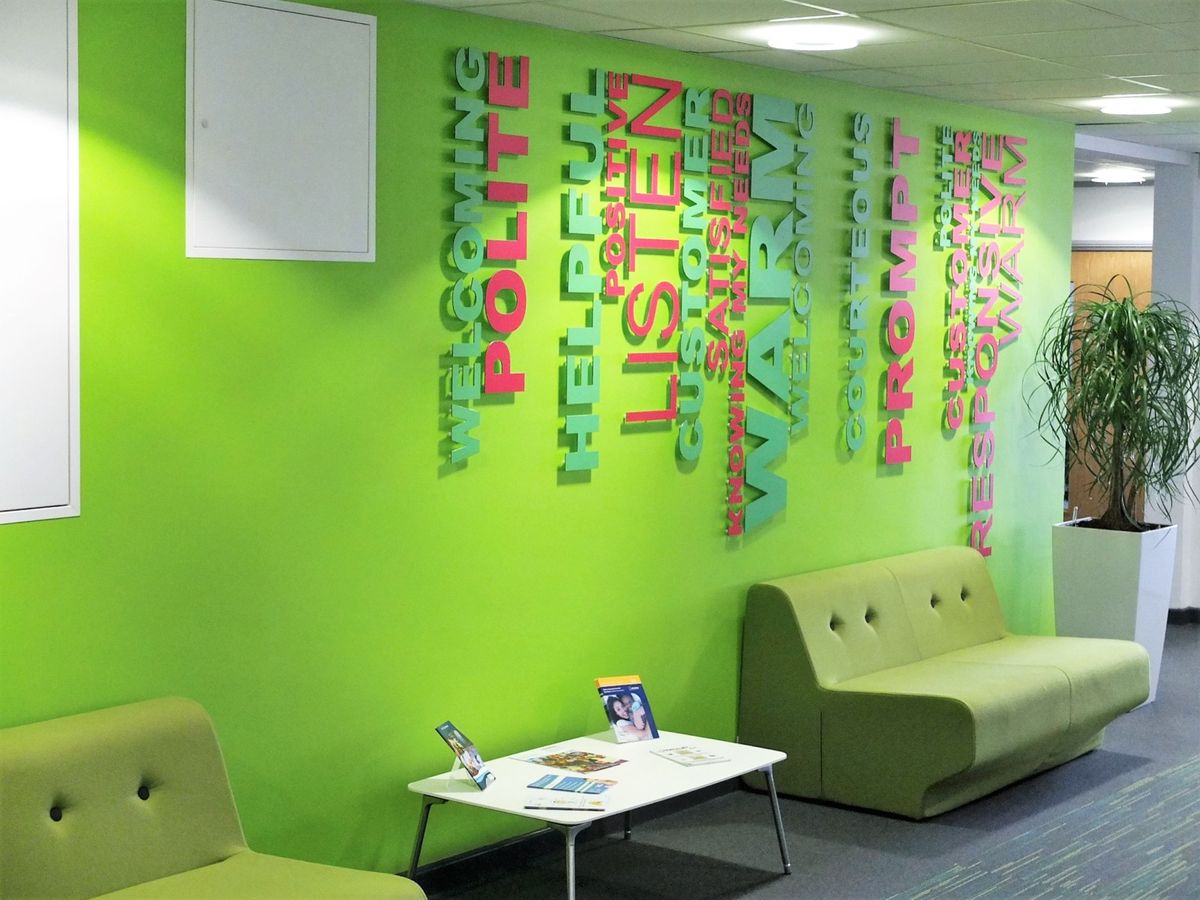 green couches against a green wall