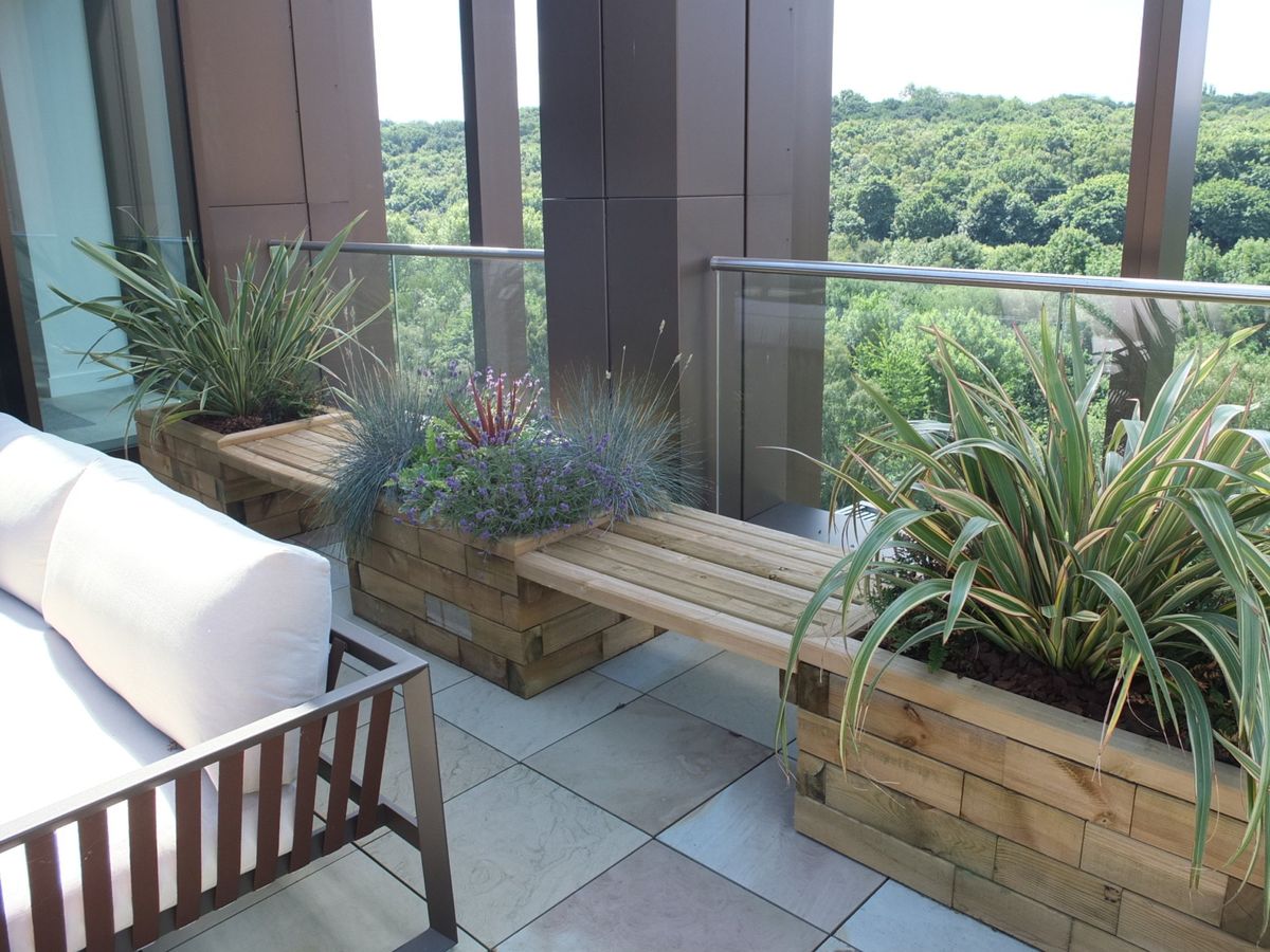 balcony area with plants and benches