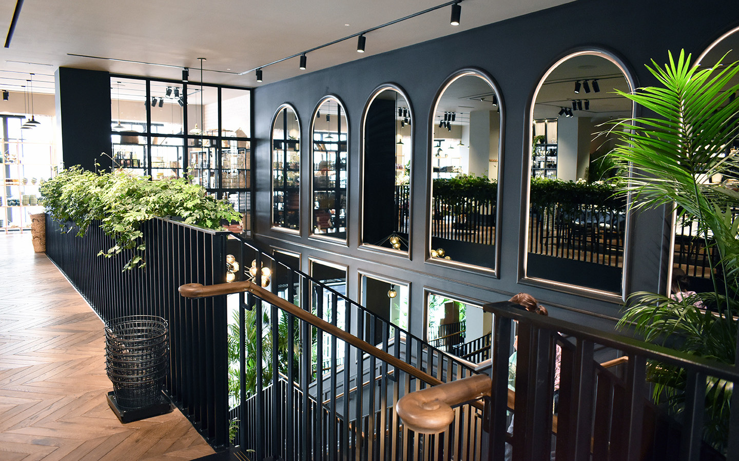 large building with black decorative walls and plants