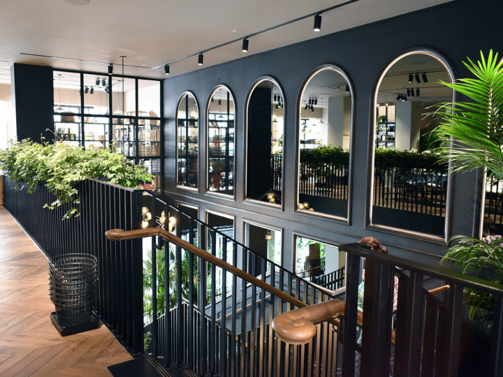 large building with black decorative walls and plants