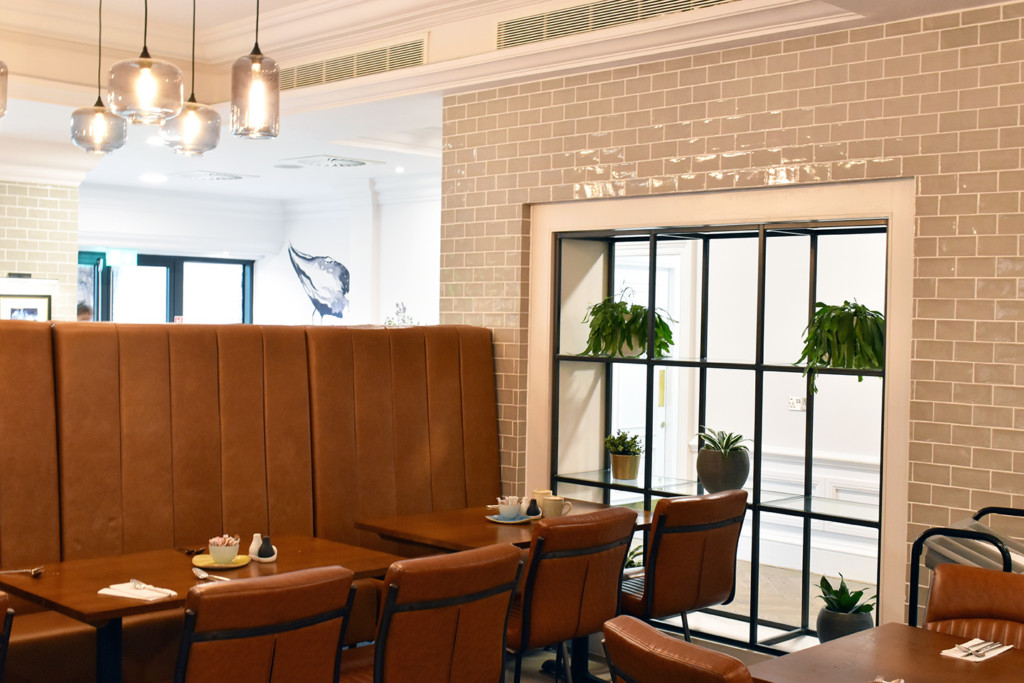 eatery with plants displayed by the window 