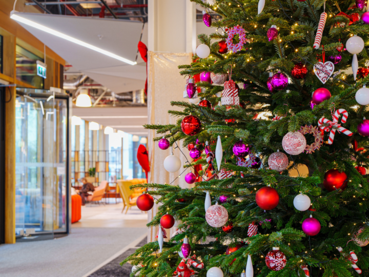 Urban Planters modern Christmas tree install with red, pink, and purple decorations