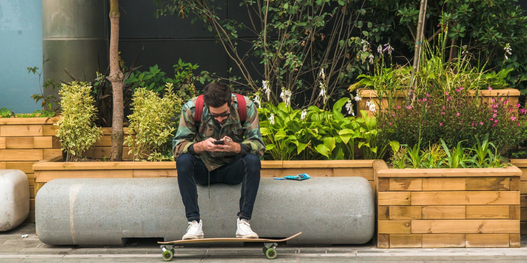 man sitting by a garden