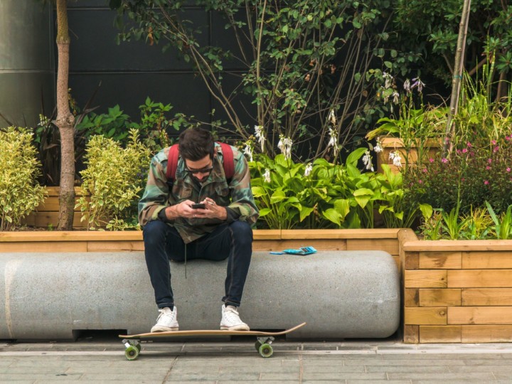 man sitting by a garden