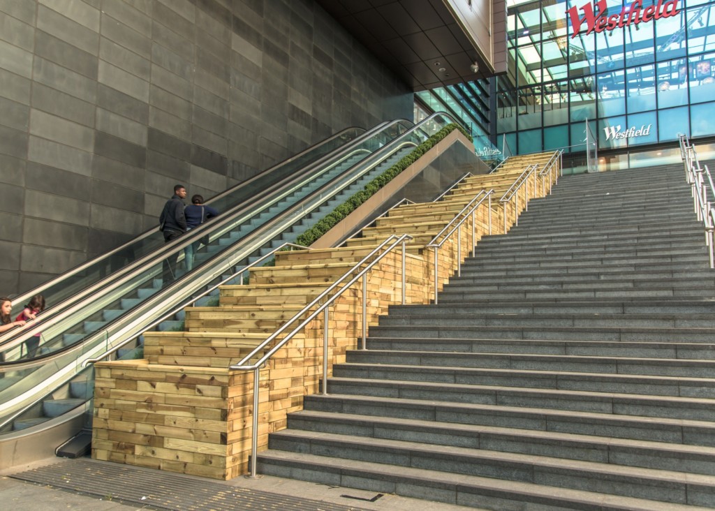  brick and wooden stairs next to escalators