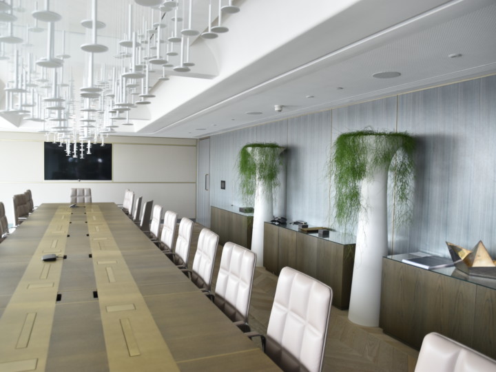 room with long table and plants displayed