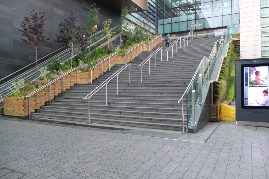 staircases with woodwork on the side with plants