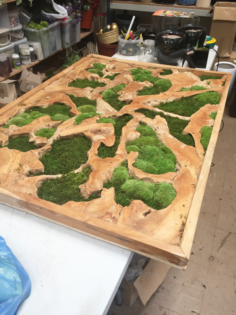 wooden artwork with moss in between 