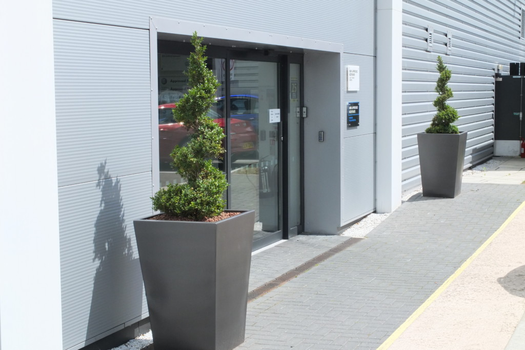 plants on display by entrance of a building