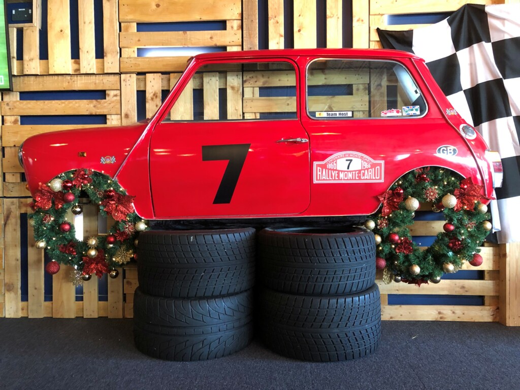 red car with christmas wreath as wheels 