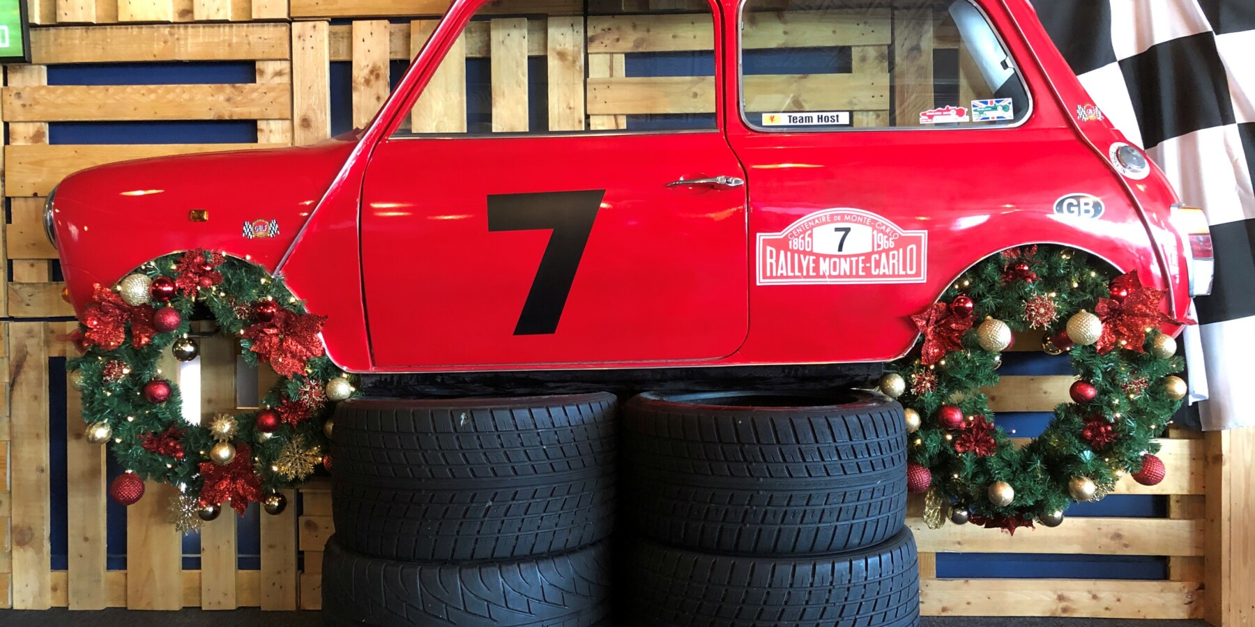 red car with christmas wreath as wheels