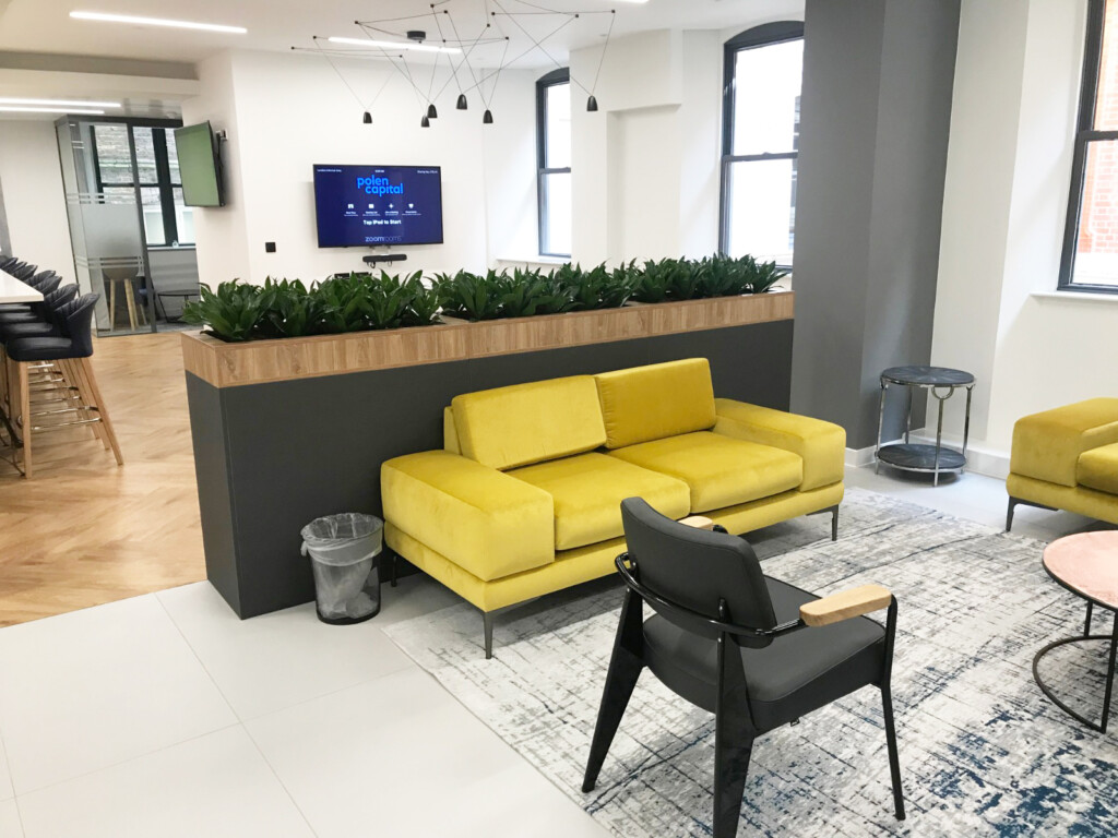 room with mustard couch with indoor plants displayed at the back