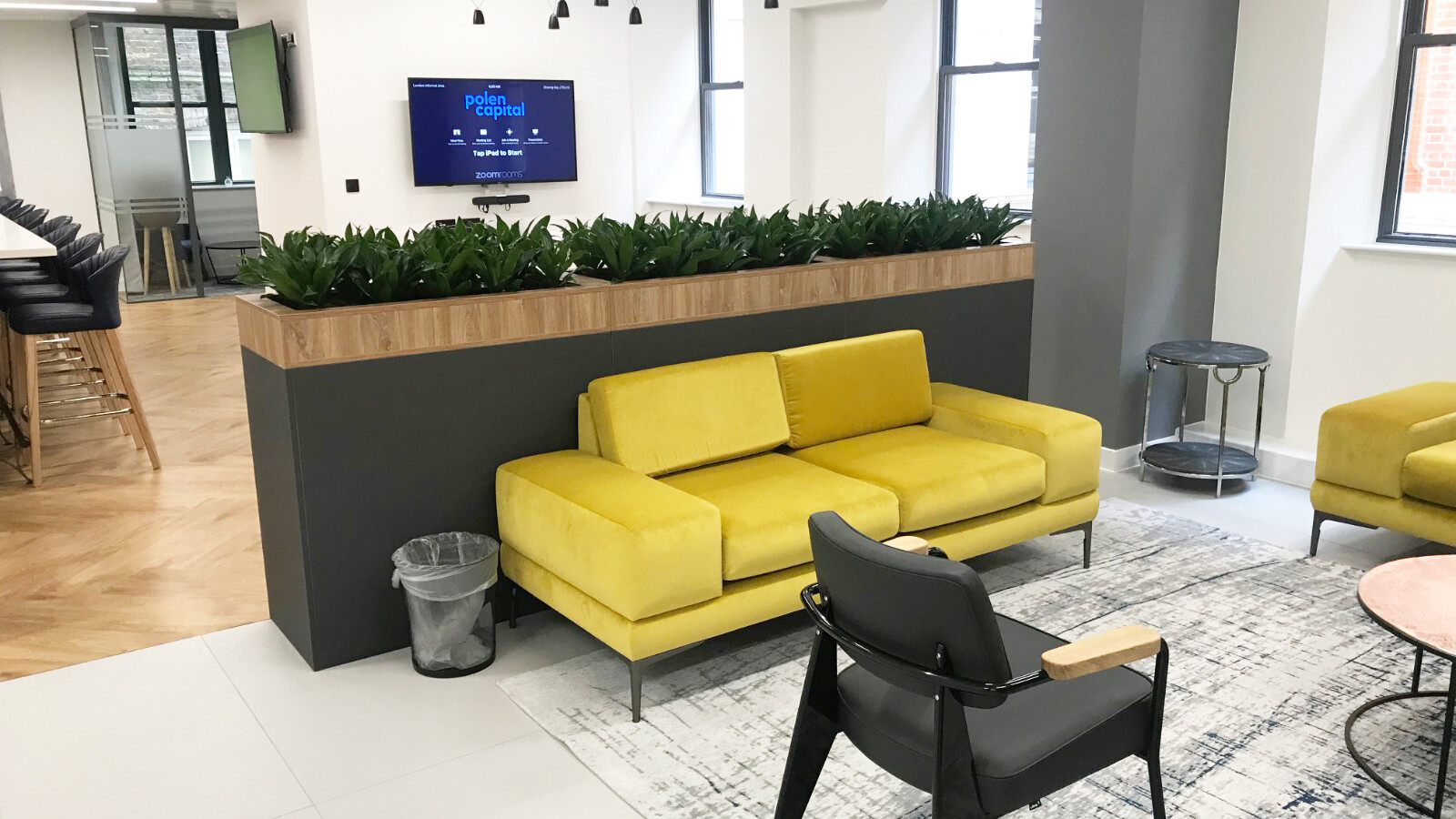 room with mustard couch and indoor plants at the back