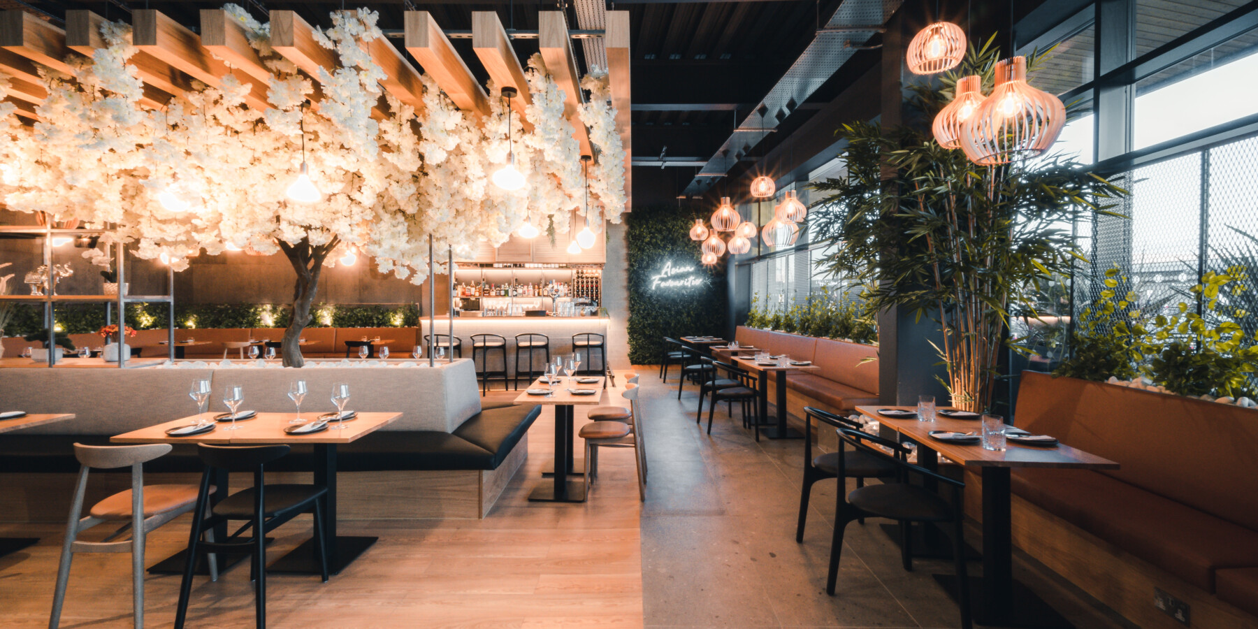 beautiful open eatery with lights on plants in the ceiling