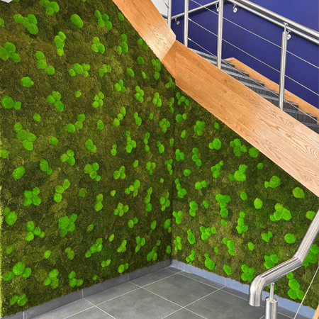 Green moss wall on the side of the stairs in an office building